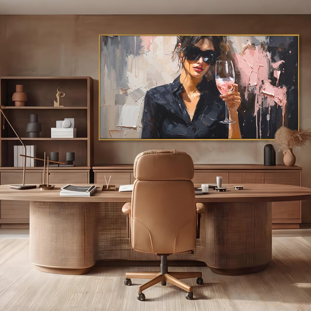 Tablou canvas cu tablou canvas cu femeie si pahar de vin, in rama de aluminiu auriu, pe perete intr-un birou
